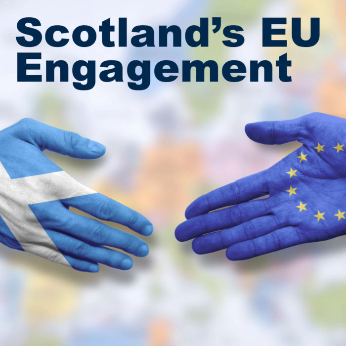 Two hands, one painted with the Scottish Saltire and the other painted with the European Union flag, shaking hands over a blurred map background. Text reads: "Scotland's EU Engagement."